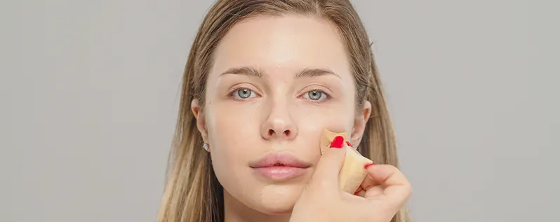 Applying concealer on the face