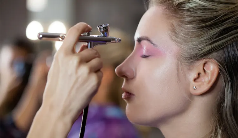 Applying airbrush makeup for oily skin