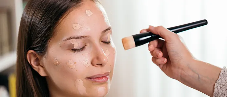 Applying a concealer all over the face as a foundation