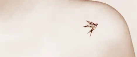 Simple bird tattoo on the shoulder